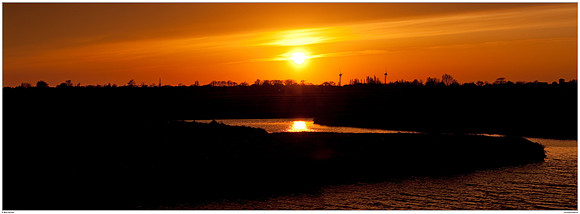 Sunset after the volcanic eruption of the Eyjafjallajökull volcano in Iceland near Hazerswoude in the meadow birds reserve De Wilck